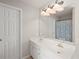 Bathroom features a large mirror above double sinks, complimented by designer lighting at 7665 Golden Sands Dr, Cumming, GA 30041