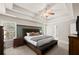 Spacious main bedroom with tray ceilings, a ceiling fan, and stylish furniture at 7665 Golden Sands Dr, Cumming, GA 30041
