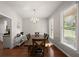 Bright dining room with hardwood floors, chandelier, and large window at 7665 Golden Sands Dr, Cumming, GA 30041
