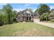 Lovely two-story home with a well-manicured lawn, basketball hoop, and attached two-car garage at 7665 Golden Sands Dr, Cumming, GA 30041