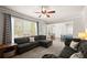 Bright living room boasts large windows, comfortable couches, and seamless access to the dining area at 7665 Golden Sands Dr, Cumming, GA 30041