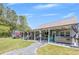 Spacious back porch with a hot tub, comfortable seating, and an outdoor entertaining area at 12 Little Creek Manor Dr, Dallas, GA 30157