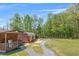 Expansive backyard featuring outbuildings, fire pit area, room to roam and recreational activities at 12 Little Creek Manor Dr, Dallas, GA 30157