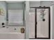 Bright bathroom showcasing a tub, glass door shower, and neutral toned tile accents at 12 Little Creek Manor Dr, Dallas, GA 30157