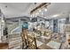 An open-concept dining room with a rustic table and easy access to the living room and kitchen at 12 Little Creek Manor Dr, Dallas, GA 30157