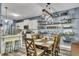 A well-lit dining area showcases a rustic table, open shelving, and a view into the kitchen, perfect for Gathering meals at 12 Little Creek Manor Dr, Dallas, GA 30157