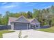 Beautiful home with a gray exterior, a well-maintained lawn, and a spacious driveway at 12 Little Creek Manor Dr, Dallas, GA 30157