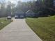 Charming single story home boasts a long driveway and a lush green front lawn at 12 Little Creek Manor Dr, Dallas, GA 30157