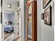 Hallway with wood floors, tall grandfather clock, and decorative framed pictures on the wall at 12 Little Creek Manor Dr, Dallas, GA 30157