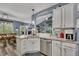 This bright kitchen offers granite countertops, stainless steel appliances, and a breakfast bar, seamlessly connecting to the dining area at 12 Little Creek Manor Dr, Dallas, GA 30157
