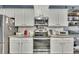 A functional kitchen featuring stainless steel appliances, white cabinets, and granite countertops for a seamless cooking experience at 12 Little Creek Manor Dr, Dallas, GA 30157
