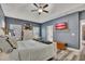 The main bedroom shows vaulted ceiling, a ceiling fan, and bright natural light through the windows at 12 Little Creek Manor Dr, Dallas, GA 30157