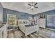 A serene main bedroom featuring a vaulted ceiling, a ceiling fan, and views through multiple windows at 12 Little Creek Manor Dr, Dallas, GA 30157