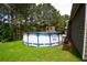 The above ground swimming pool is in a backyard with trees and a house at 142 Susie Creek Ln, Villa Rica, GA 30180