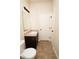 Bathroom with dark vanity, speckled countertop, mirror, and linoleum flooring at 142 Susie Creek Ln, Villa Rica, GA 30180