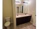 Bathroom featuring double sinks, a large mirror, and new lighting fixtures at 142 Susie Creek Ln, Villa Rica, GA 30180