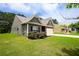 Attractive one-story home with an attached garage, verdant lawn, and blooming rose bushes at 142 Susie Creek Ln, Villa Rica, GA 30180