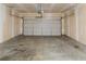 Spacious, unfinished two-car garage with overhead door and ample room for parking at 142 Susie Creek Ln, Villa Rica, GA 30180