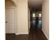 Inviting hallway with hardwood floors leading to an open living space featuring a fireplace at 142 Susie Creek Ln, Villa Rica, GA 30180