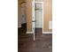 Hallway featuring vinyl flooring, molding, and a view of a walk-in closet at 142 Susie Creek Ln, Villa Rica, GA 30180