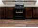 Kitchen featuring black appliances, granite countertops, and dark wood cabinetry at 142 Susie Creek Ln, Villa Rica, GA 30180