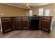 Kitchen island with dark wood cabinets, countertop, stainless sink and dishwasher at 142 Susie Creek Ln, Villa Rica, GA 30180