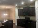 Well-equipped kitchen with dark cabinets, granite countertops, stainless steel appliances, and hardwood floors at 142 Susie Creek Ln, Villa Rica, GA 30180