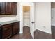 Kitchen with pantry and dark wood cabinets at 142 Susie Creek Ln, Villa Rica, GA 30180