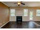 Bright living room with hardwood floors, fireplace, and natural light from large windows at 142 Susie Creek Ln, Villa Rica, GA 30180