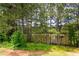 Scenic view of property's pond surrounded by lush greenery and mature trees at 142 Susie Creek Ln, Villa Rica, GA 30180