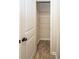 A walk-in closet has a white door, shelving, and tile floor at 142 Susie Creek Ln, Villa Rica, GA 30180