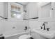 Well-lit bathroom featuring a tub and shower combination, white subway tile, and modern fixtures at 20 Collier Nw Rd # 11, Atlanta, GA 30309