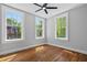 Bedroom featuring hardwood floors, fan and natural light streaming through the three windows at 20 Collier Nw Rd # 11, Atlanta, GA 30309