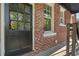 Charming front door, with exposed brick siding and a window, creating an inviting entrance at 20 Collier Nw Rd # 11, Atlanta, GA 30309