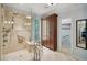 Luxurious bathroom with a glass-enclosed shower, tile flooring, and elegant fixtures at 2095 Southers Cir, Suwanee, GA 30024