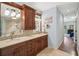 Elegant bathroom featuring dual sinks, a decorative mirror, and natural stone accents at 2095 Southers Cir, Suwanee, GA 30024