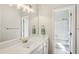 Bathroom with white vanity, large mirror, and shower over tub combination at 2095 Southers Cir, Suwanee, GA 30024