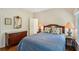 Comfortable bedroom featuring hardwood floors, a large bed, and antique decor at 2095 Southers Cir, Suwanee, GA 30024