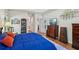 Well-appointed bedroom with wood floors, sophisticated decor, and a view into the hall at 2095 Southers Cir, Suwanee, GA 30024