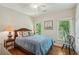 Inviting bedroom with tranquil lake views, hardwood floors, and soft, natural lighting at 2095 Southers Cir, Suwanee, GA 30024