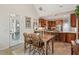 Dining area featuring stone floors, a table, and views of the kitchen and outdoor patio at 2095 Southers Cir, Suwanee, GA 30024