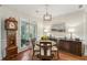 Formal dining room with hardwood floors, wainscoting and a large window for natural light at 2095 Southers Cir, Suwanee, GA 30024