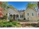 Well-maintained home features a charming covered porch, landscaped yard, and inviting curb appeal at 2095 Southers Cir, Suwanee, GA 30024