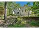 Charming home exterior featuring lush landscaping, a serene stream, and a well-maintained yard at 2095 Southers Cir, Suwanee, GA 30024