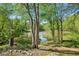 Beautiful lake view surrounded by mature trees and lush greenery with bright sunshine at 2095 Southers Cir, Suwanee, GA 30024