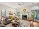 Bright living room featuring hardwood floors, a cozy fireplace, and views of the outdoors at 2095 Southers Cir, Suwanee, GA 30024