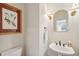 Cozy powder room with pedestal sink, elegant fixtures, and attractive decorative artwork at 2095 Southers Cir, Suwanee, GA 30024