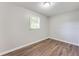 Bright bedroom with wood-look floors, natural light and neutral paint at 5032 Central Church Rd, Douglasville, GA 30135