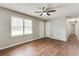 Bright bedroom featuring wood floors, a ceiling fan, and a window with natural light at 5032 Central Church Rd, Douglasville, GA 30135
