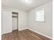 Comfortable bedroom featuring wood-look floors, closet and natural light at 5032 Central Church Rd, Douglasville, GA 30135